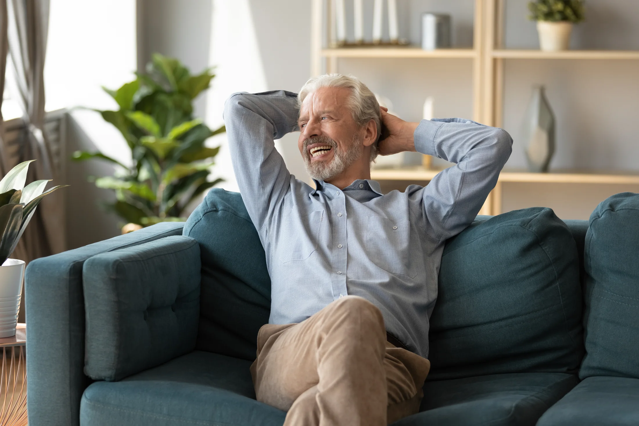 Relaxed older man smiling at home